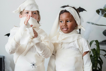 Two children wearing home made mummy Halloween costumes. Photo by Mike Jones