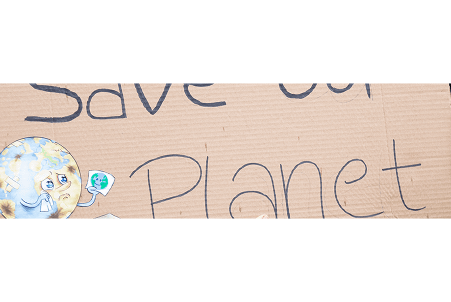 Climate protester holding 'save ourplanet' sign 