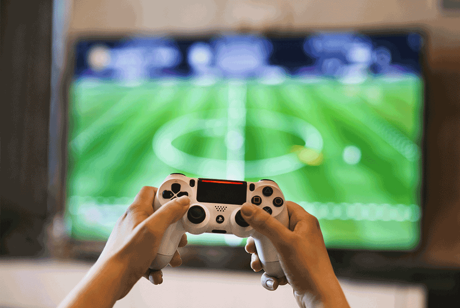 Playstation 5 (PS5) controller playing game on TV. 