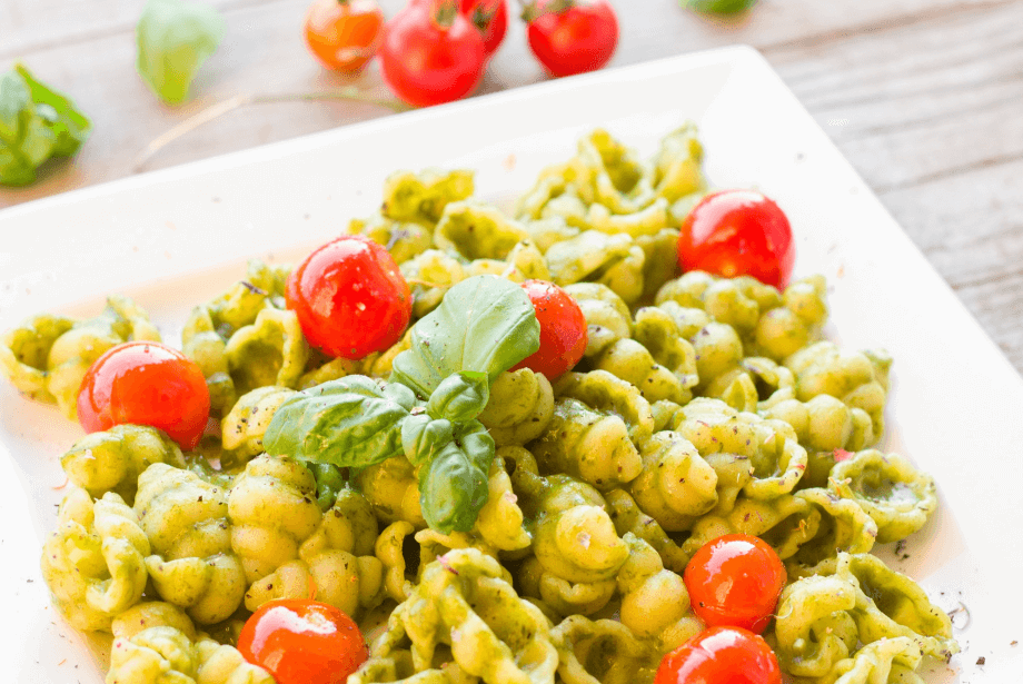 A bowl of juicy pesto covered pasta
