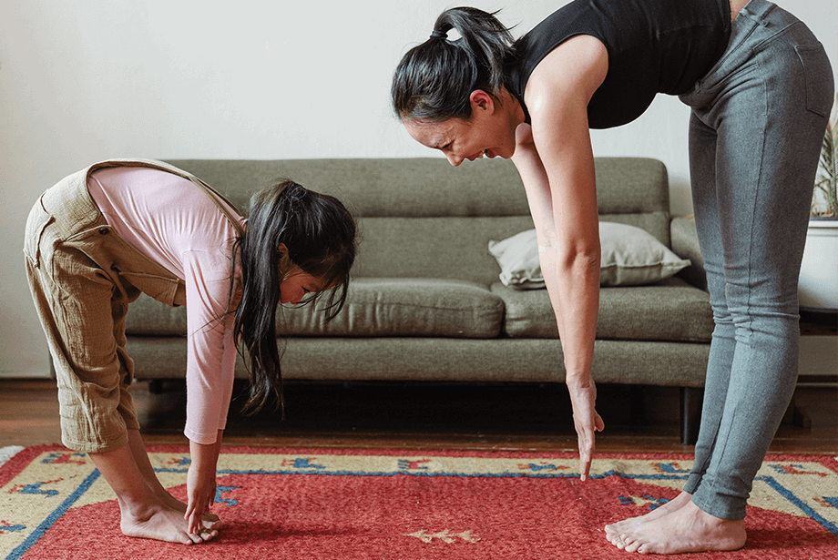 Mother and daughter exercising at home 