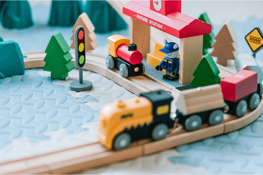 Picture of children's wooden train set with train, track and trees. Photo by Jerry Wang on Unsplash 