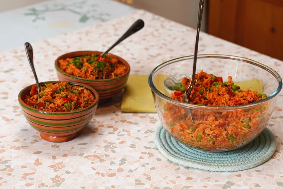 Large serving bowl of microwave jambalaya and two small bowls with individual portions