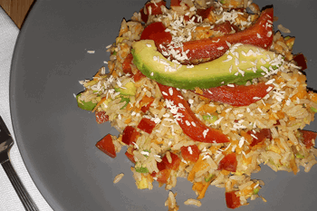 A bowl of brown rice topped with colourful veg and coconut