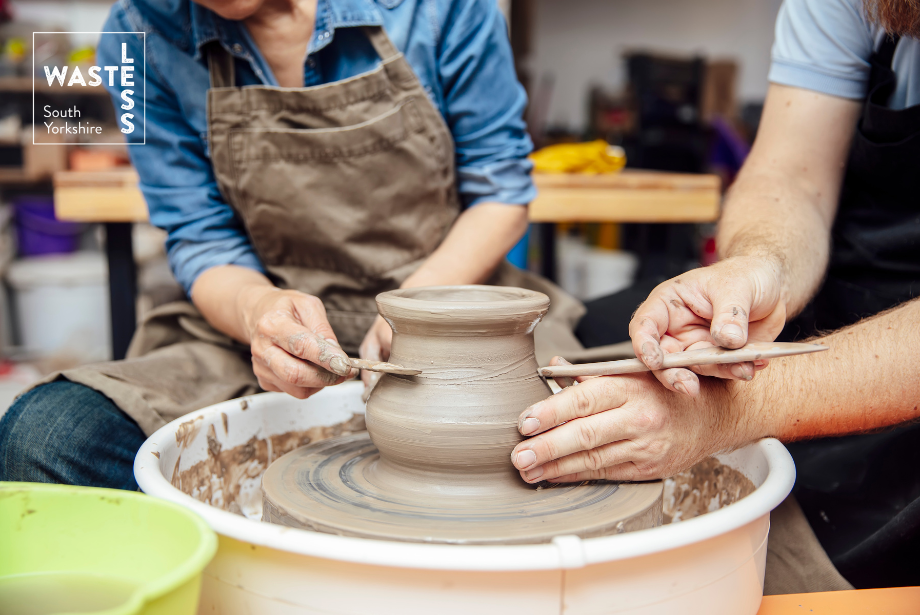 Image of two people using a pottery wheel.