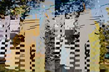 clothes airing on a washing line. Photo by Karolina Grabowska: https://www.pexels.com/photo/clothes-drying-on-rope-with-clothespins-in-garden-4495705/