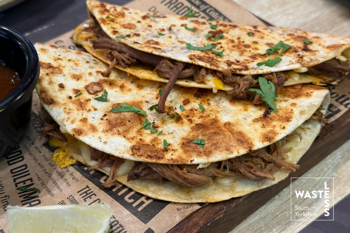 Quesadillas with pulled meat, cheese, coriander and lime.
