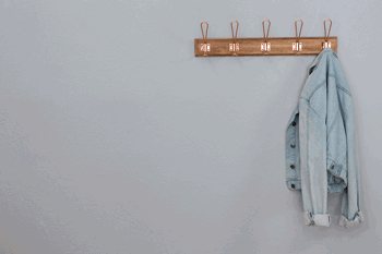 Denim jacket hanging on coat hook